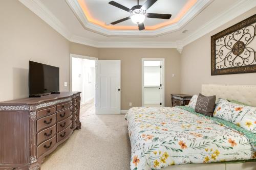 a bedroom with a bed and a flat screen tv at Charming Alabama Retreat with Patio and Pool Access! in Owens Cross Roads