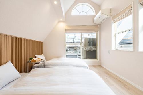 Säng eller sängar i ett rum på Hotel STAY ARI Higashishinjuku