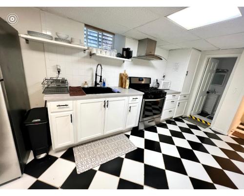 a kitchen with a black and white checkered floor at 6-A Diamond in Yonkers, NY in Yonkers
