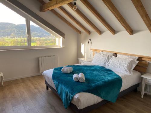 a bedroom with a large bed with a large window at Gîte spacieux 10 pers à Vagney - Sauna, jeux, proche Gérardmer - FR-1-589-400 in Vagney