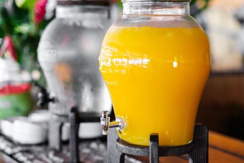 a glass jar of orange juice sitting on a table at Beachcomber Island Resort in Beachcomber Island