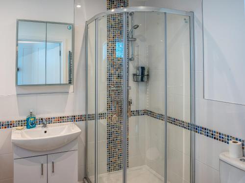 a bathroom with a glass shower and a sink at The Old Canoe Club in Millbrook