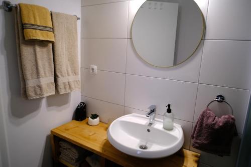 a bathroom with a sink and a mirror and towels at Apartments with parking space Plaski, Velebit - 21935 in Plaški