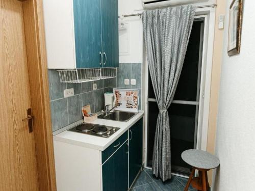 een kleine keuken met een wastafel en een fornuis bij Apartments by the sea Komarna, Neretva Delta - Usce Neretve - 21938 in Klek