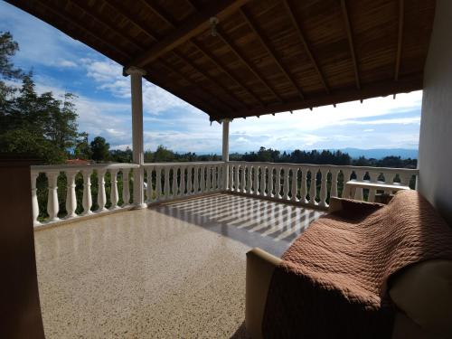 a balcony of a house with a view at Casa de campo Jade, Rionegro in Rionegro
