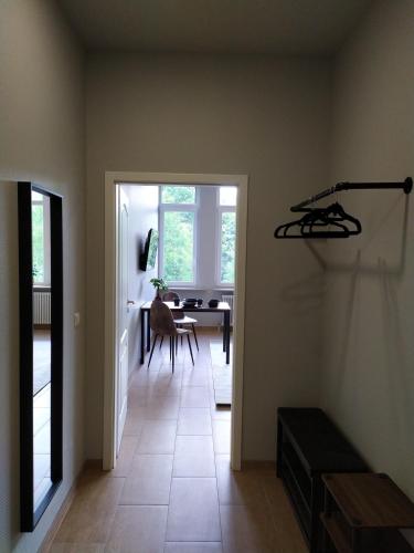 a hallway with a door leading to a dining room at Andris Apartments in Stuttgart