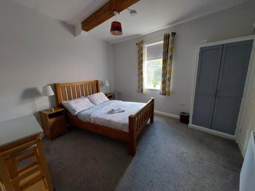 a bedroom with a bed and a window at Southwell Stays in Southwell