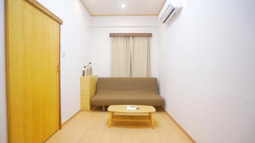 a small room with a couch and a table at Tokyo Ueno Expert Hotel in Tokyo