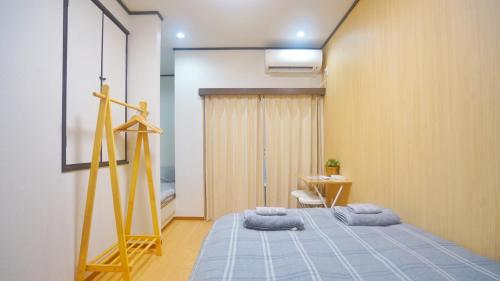 a bedroom with a bed with towels on it at Tokyo Ueno Expert Hotel in Tokyo