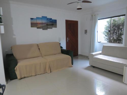 a living room with a couch and a chair at Recanto do Mundaí - Apto 101 in Porto Seguro