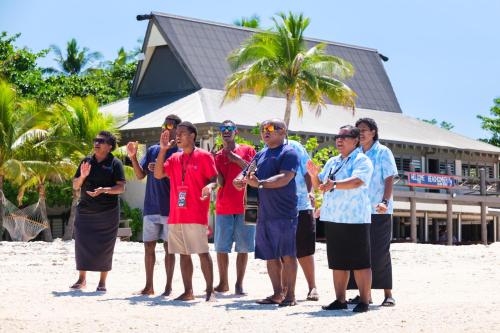 a group of people standing on the beach at Beachcomber Island Resort in Beachcomber Island