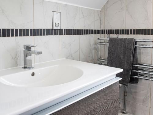 a bathroom with a white sink and a towel at Little Willow in Saint Columb Major