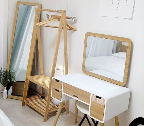 a dressing table with a mirror and a desk at Stay Mono in Incheon