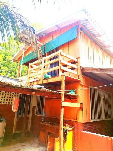 a house with a staircase on the side of it at Casa de férias e camping in São Félix do Xingu
