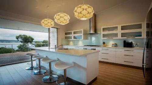 a kitchen with a large island with bar stools at Seasalt in Coffin Bay