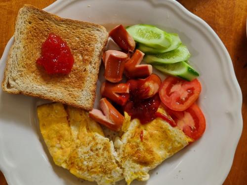 a plate of food with toast and vegetables on it at Sawasdee Sichang Resort in Ban Tha Thewawong