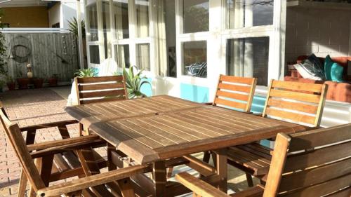 a wooden table and chairs on a patio at Willygunyah in Coffin Bay