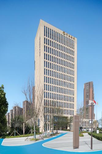 a rendering of a tall building in a city at Citadines Jinqiao Building Yantai in Yantai