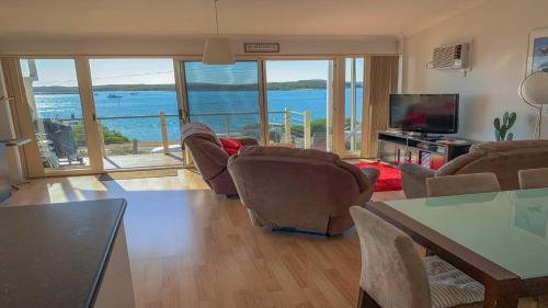 a living room with a view of the ocean at Seascape in Coffin Bay