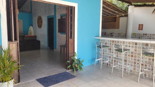a house with a blue wall and a doorway at República Francês in Marechal Deodoro