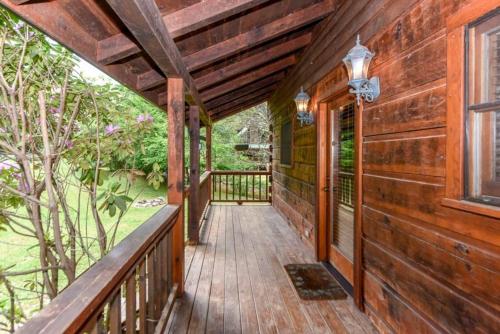 a wooden porch of a wooden house with a window at Creekside cabin in Townsend