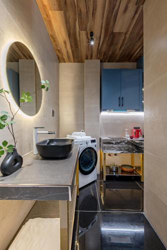 a kitchen with a sink and a bowl on a counter at Skycure Serviced Apartments in Ho Chi Minh City