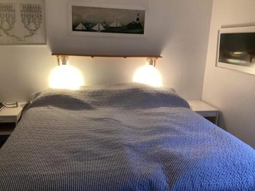 a bedroom with a bed with two lights on it at 4 star holiday home in TORHAMN-By Traum in Torhamn