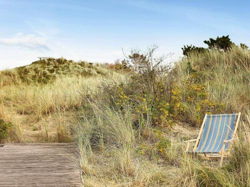 a blue beach chair sitting on a boardwalk at 6 person holiday home in Ålbæk-By Traum in Ålbæk