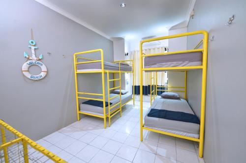 a room with two bunk beds and a staircase at Bunk Bed and Breakfast in Yogyakarta