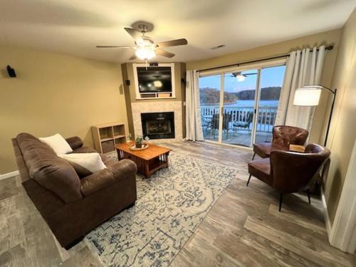 a living room with a couch and chairs and a fireplace at Condo at Parkview Bay - Your Lakefront Oasis in Osage Beach