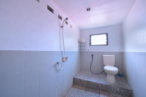 a bathroom with a toilet and a shower at Bunk Bed and Breakfast in Yogyakarta