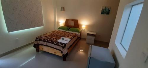 a small bedroom with a bed and a window at II IMPERIO in Cieneguilla