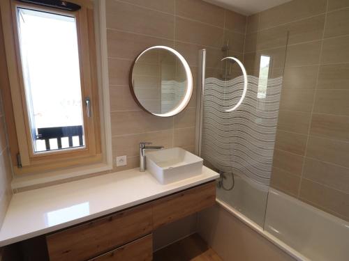 a bathroom with a sink and a mirror at Appartement lumineux skis aux pieds avec balcon - FR-1-502-541 in Tignes