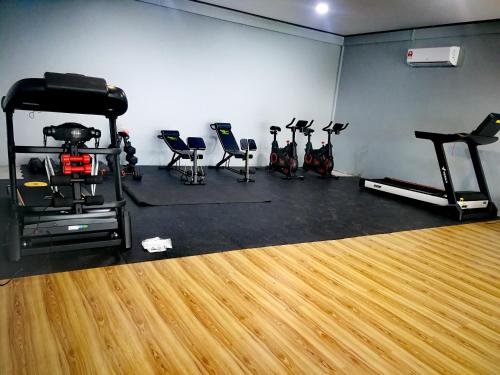 a gym with a bunch of exercise bikes in a room at Marina Hotel 