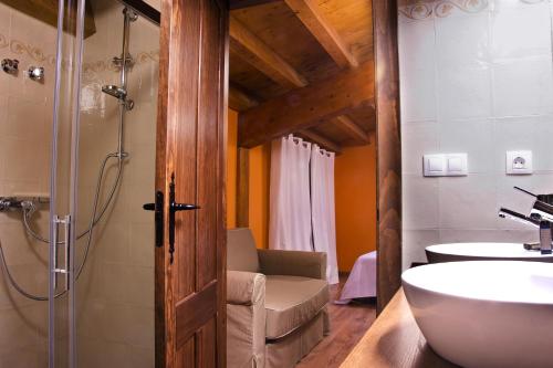 a bathroom with a shower and a sink and a toilet at La Casona de la Mesta in Almajano