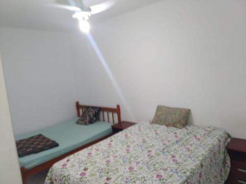 a bedroom with a bed and a bench in it at AP beira mar perto do centro in Capão da Canoa