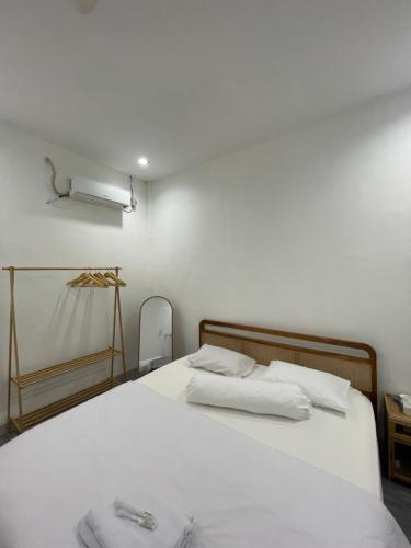 a bedroom with a white bed with two towels on it at Bagus house in Pekanbaru