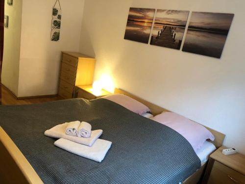 a bedroom with a bed with towels on it at Haus am Wald in Hohndorf