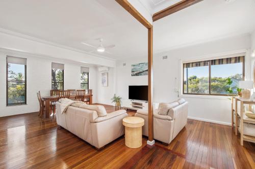 a living room with two couches and a tv at Dusties 5 Pacific Street South West Rocks - Full Linen Provided in South West Rocks