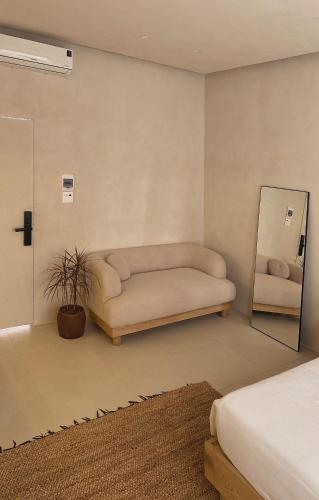 a living room with a couch and a mirror at AMBERGRIS in Tuy Hoa