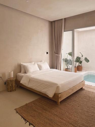 a bedroom with a large bed and a swimming pool at AMBERGRIS in Tuy Hoa