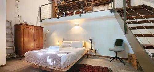 Un pequeño dormitorio con una cama y una escalera en Central New York-Style Loft en Sídney