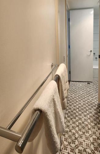 a bathroom with towels hanging on a wall at Phillip Island Apartments in Cowes