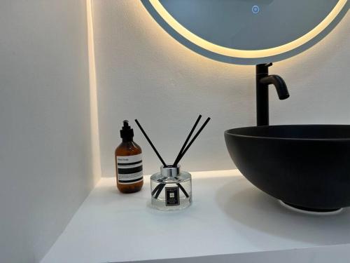 a bathroom counter with a black bowl and a mirror at Pawikan Seaview Villa in Moalboal