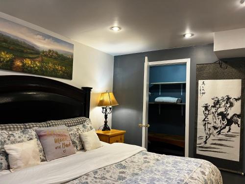 a bedroom with a bed and a painting on the wall at hidden valley new basement suite with private bathroom! in Calgary