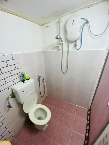 a small bathroom with a toilet and a shower at Simple2 Guesthouse in Pantai Cenang