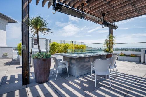 a patio with a table and chairs on a roof at Redwood City 2BR w WD Pool BBQ nr Caltrain SFO-506 in Redwood City