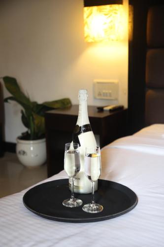 a bottle of champagne and two glasses on a tray at Casabela Boutique Hotel in Porvorim