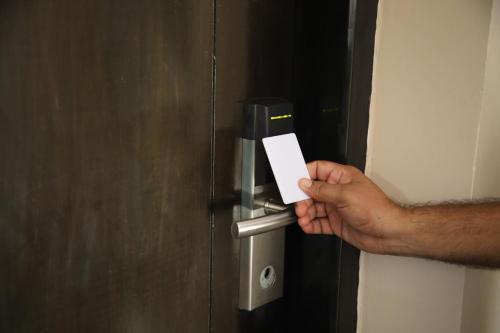 a person holding a piece of paper in a door at Casabela Boutique Hotel in Porvorim