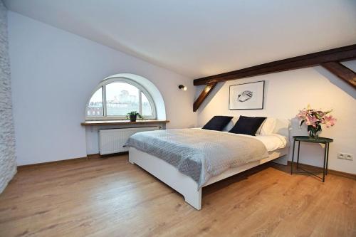a bedroom with a large bed and a window at FV/ Mariacka 7 - Studio apartment -Katowice in Katowice